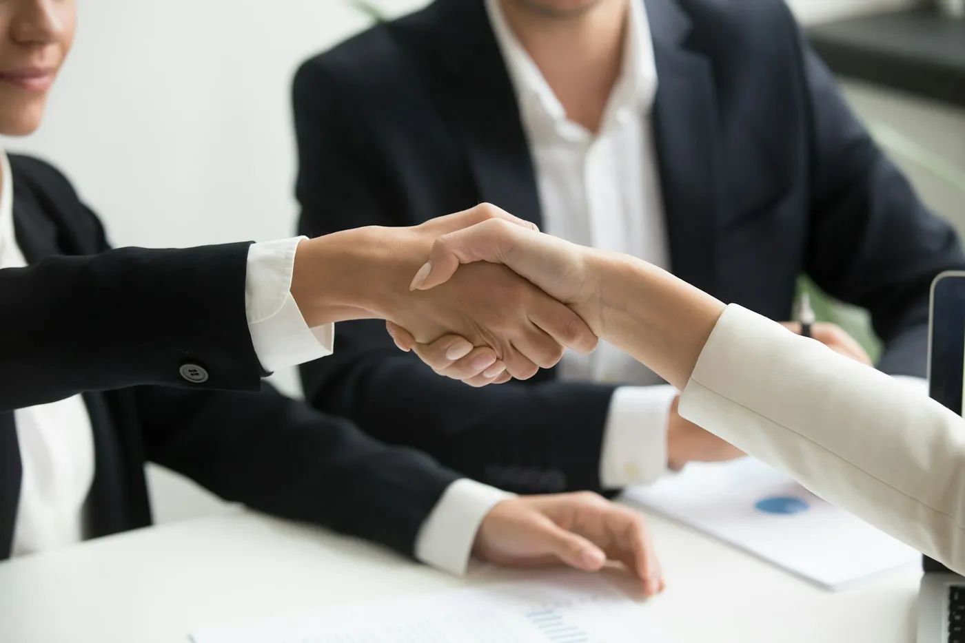 Two partners shaking hands to close a deal